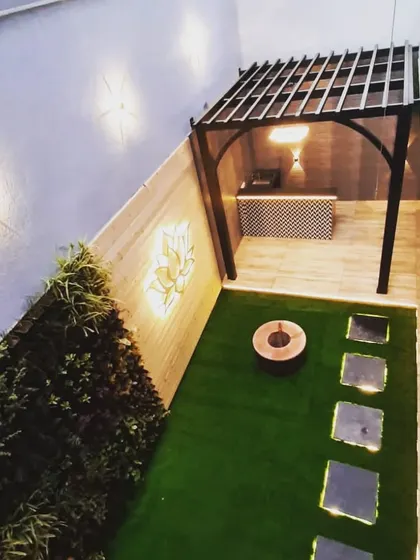 An overhead view showing how the pergola neatly defines the bar and seating area in this narrow backyard space.