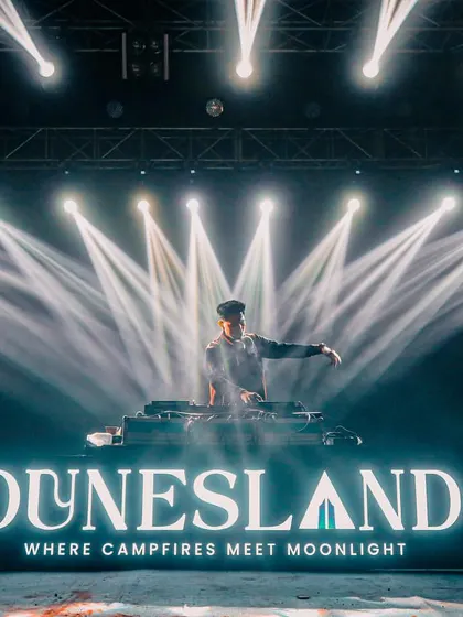 On stage at the Dunesland festival, where I delivered a headline performance. This image showcases the professional, large-scale stage presence I bring, complete with custom branding and a massive light show.