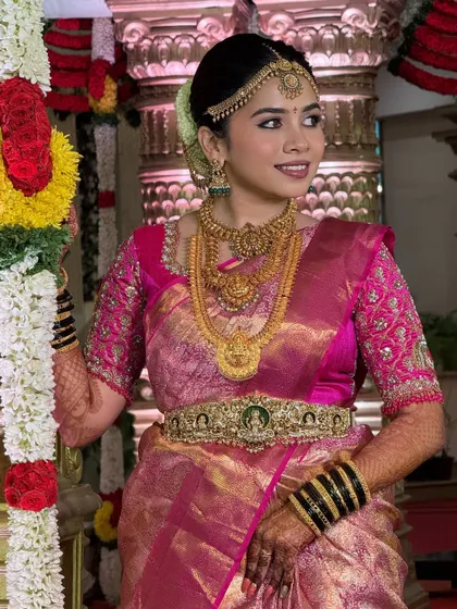 The complete look in the temple setting. The makeup, hair, and saree all come together to create a look that is both traditional and breathtakingly beautiful.