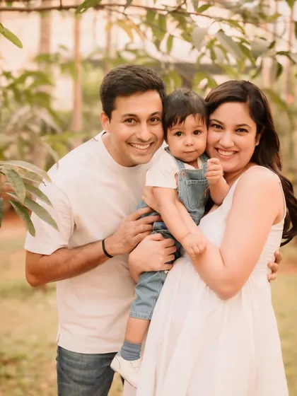A beautiful, classic family portrait taken under the soft light of the trees.