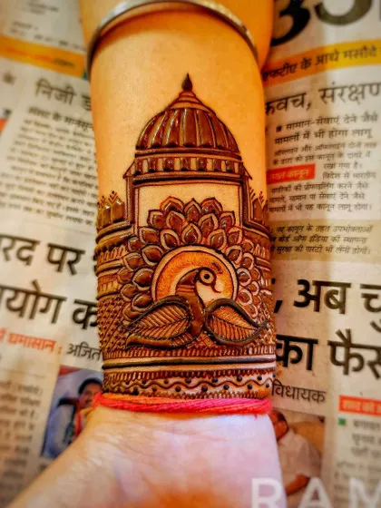 A wrist cuff design showing a peacock in front of a large dome, with a lotus base. The details create a beautiful 3D effect.