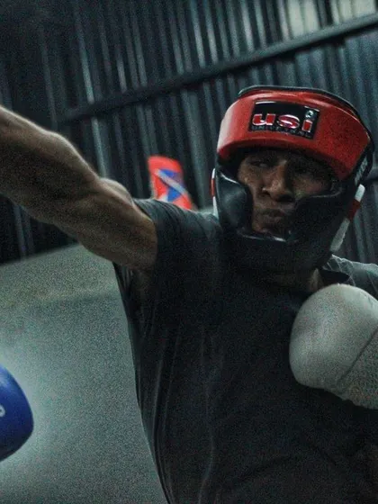 A fighter throws an overhand right during a sparring session. This punch requires timing and power to be effective.