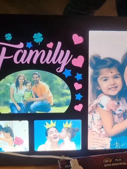 A custom LED frame designed with a 'Family' theme. It combines multiple photos in different shapes and sizes, creating a vibrant and heartwarming collage that lights up beautifully.