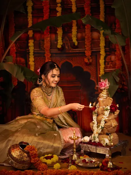 A beautiful moment of devotion as the woman lights an incense stick for the Ganesha puja.
