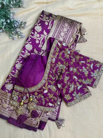 A beautiful purple Banarasi saree paired with a matching fully embroidered blouse.