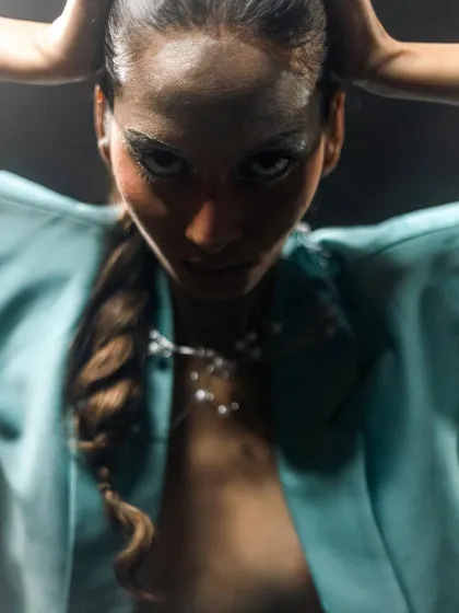 A dramatic close-up from the "Metaverse" shoot, focusing on the metallic eye makeup and the intricate rope braid hairstyle.