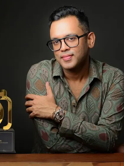 A profile shot for award-winning designer Shantanu Garg, pictured with his Mid-Day Showbiz Icon award. This highlights his professional achievements.