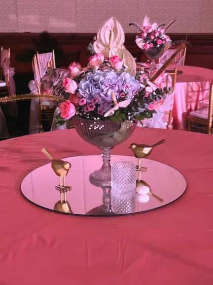 For this whimsical garden reception, we used glowing LED dragonflies and birds nestled among pastel floral arrangements. These unique lighting elements added a touch of magic and sophistication to the decor.