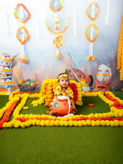 Tiny Krishna tales, told with flowers and festive colors. This beautiful setup with marigold garlands and painted matkis is the perfect backdrop for a Janmashtami celebration.