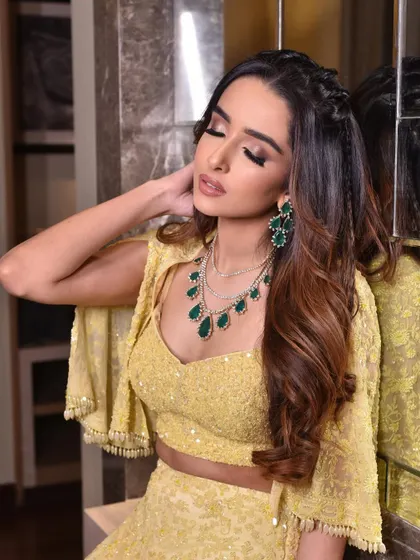 A closer look at this cocktail-ready hairstyle. The front sections are braided back to keep hair away from the face, while the rest flows in voluminous waves.