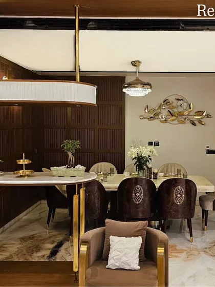 The completed dining and bar area in the Harmony Home, showcasing the custom-curved breakfast counter and the rich textures of the wood-paneled walls.