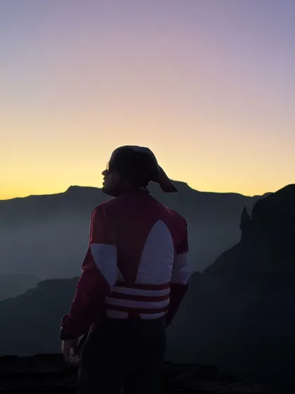 A trekker watches the sunrise from the top of Ratangad fort. The early morning start is always worth it for views like this.