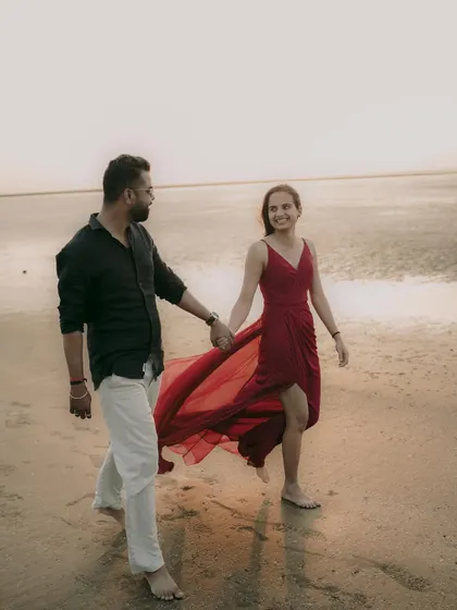 A happy, walking shot on the beach, capturing the couple's easy and natural chemistry.