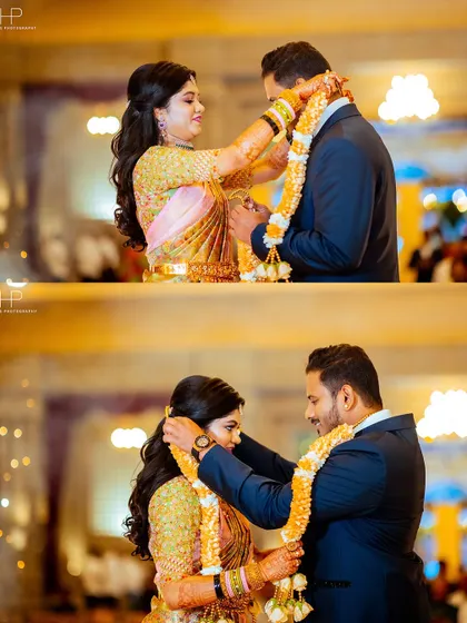 The couple exchanging garlands at their reception, a beautiful moment of welcome.