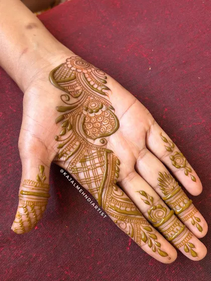 A fresh application of an Arabic henna design, showing the glossy paste.