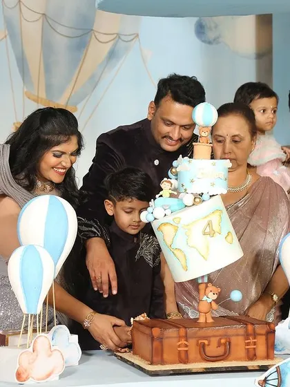 A close-up of the cake cutting at the hot air balloon party.