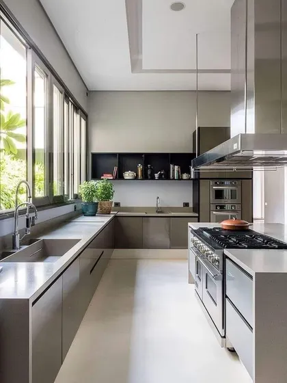 This minimalist kitchen uses flat-panel, handleless cabinets in a matte grey finish. The large windows and professional-grade appliances make it a dream for any serious home cook.
