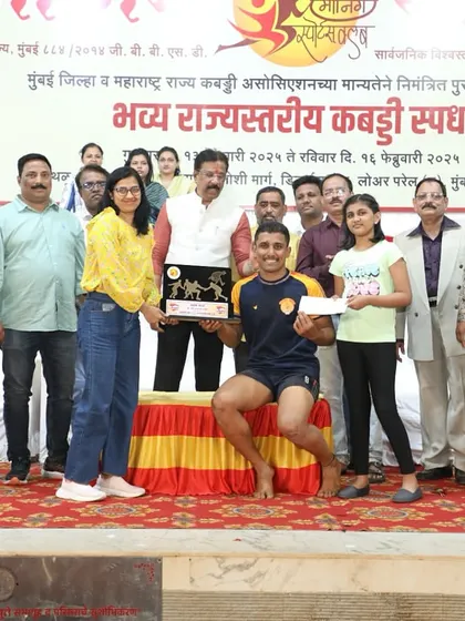 Ajinkya receiving his 'Best Raider' award on stage.