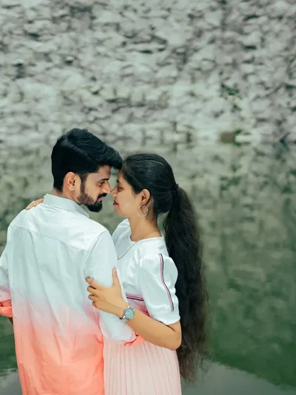 A duplicate of ID 17, this photo captures a tender embrace by the water's edge, highlighting the couple's affection in a serene natural setting.