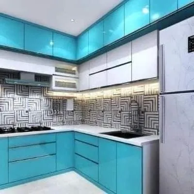 A vibrant kitchen with turquoise cabinets and a geometric black-and-white backsplash. This design shows how to use bold color and pattern in a modern way.