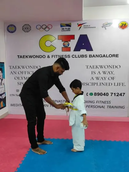 Tying a yellow belt.