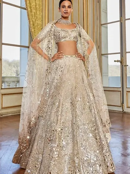 A mirror-work lehenga is perfect for a sangeet. Inspired by this look, I can design a dazzling, light-catching outfit that's perfect for a night of dancing.