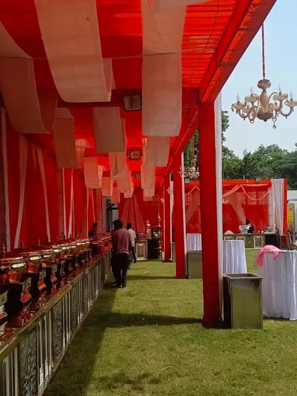 This shows the catering section I set up for a political function. The red and white tent covering, complete with a chandelier, ensures that even the dining area matches the event's professional and organized standard.