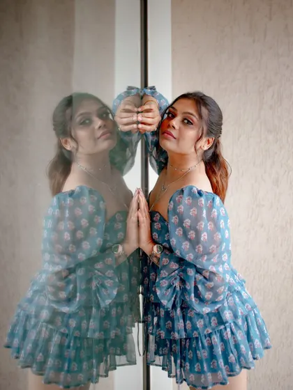 A creative portrait using a mirror reflection. The model's pose and the reflection create an artistic and visually interesting image.