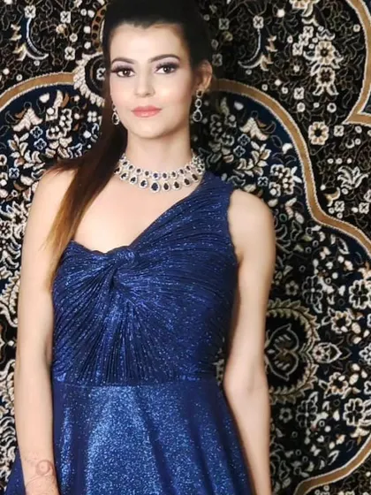 This shimmering blue gown is accessorized with a beautiful American Diamond necklace set. The design is modern and chic, perfect for an evening event.