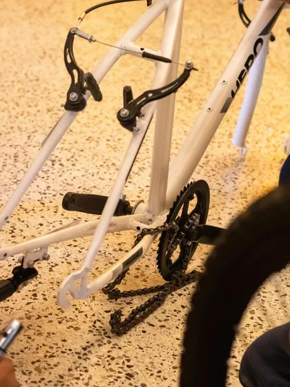 The bike is partially disassembled, showing the frame and drivetrain. This view helps students understand how the different mechanical systems work together.