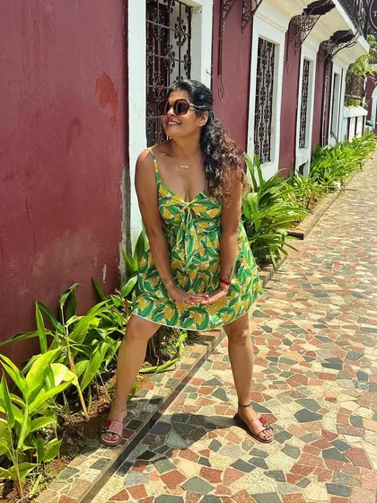 Posing in the Latin Quarters of Goa. The bright colors of my dress stand out beautifully against the historic architecture.