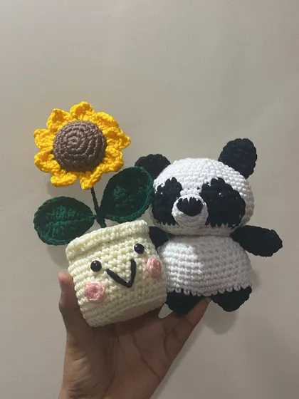 A custom order for a panda and a smiley sunflower pot. It shows that I can create other characters and items to go along with my forever flowers.
