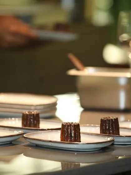 A lineup of Canelés, ready to be served as the final sweet bite of the evening.