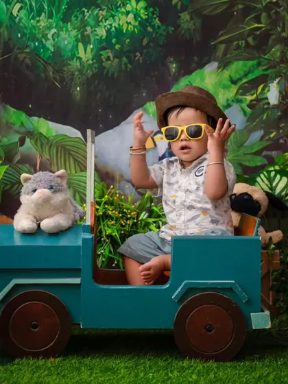 A cool dude on a jungle safari. The sunglasses and jeep prop add a fun and adventurous twist to this jungle-themed shoot.
