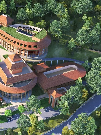 An aerial perspective of the university's academic and administrative blocks, showcasing the use of green roofs and organic forms. The layout is planned to optimize views, daylight, and pedestrian connectivity across the sprawling campus.