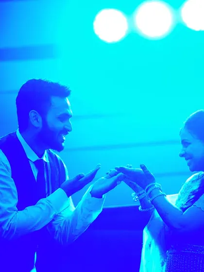 A playful moment during their dance, filled with smiles and energy.