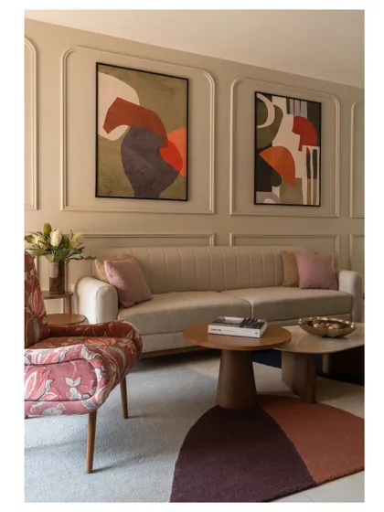 A closer look at the living area, where a floral accent chair and a multi-toned rug add layers of color and pattern to the neutral base.