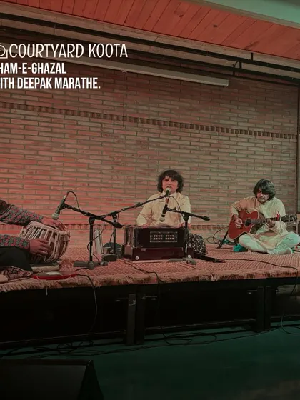 A beautiful shot from the "Sham-e-Ghazal" with Deepak Marathe. The image captures the serene and soulful ambiance of a ghazal evening at Koota, with the artists seated traditionally on the stage.