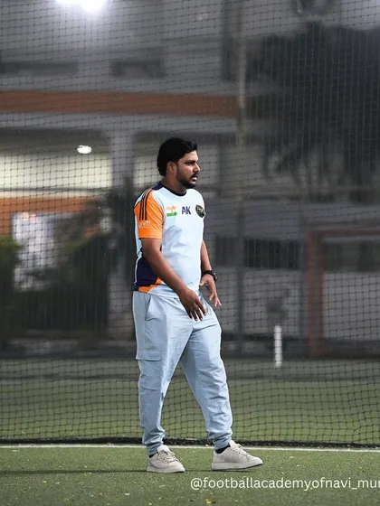 A coach observes the training session from the sidelines, constantly assessing player performance and looking for areas of improvement.
