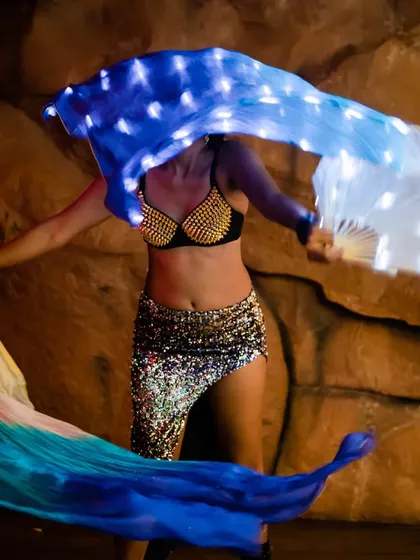The LED veil fans in motion. The flowing silk and bright lights create a mesmerizing dance of color and movement.
