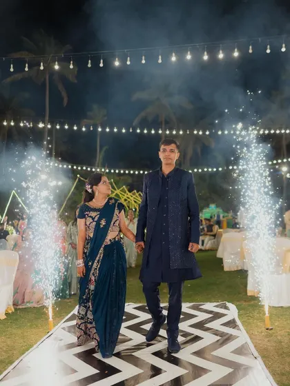 A candid shot of the couple enjoying their walk down the aisle at their Sangeet, surrounded by the magical ambiance we created with lights and special effects.