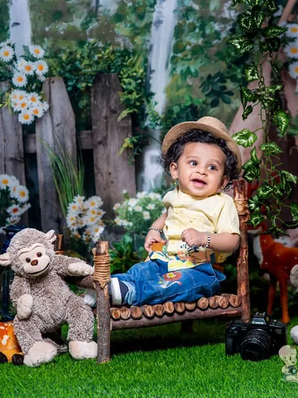A curious little boy in a woodland setting, surrounded by his plush animal friends. The natural colors and textures create a calm and gentle atmosphere.