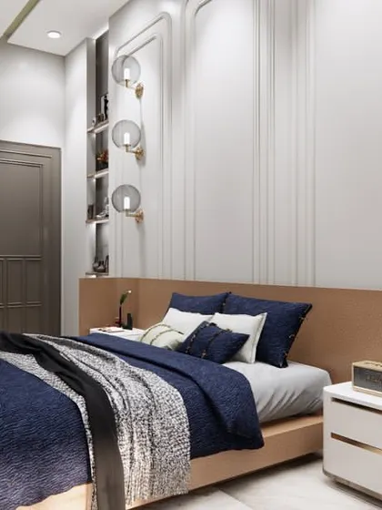 We designed this bedroom to be a beautiful and serene space. The room features a striking blue and white color scheme, a unique pink dressing table, and modern lighting fixtures for a chic and contemporary feel.