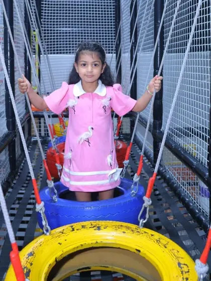 Navigating the tire bridge is a fun challenge within our multi-level play structure.