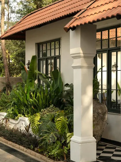 Views of the courtyard at Elgin Cafe, a space designed for pause and reflection. I used white lime-washed walls, lush tropical plants, and classic lantern-style lighting to create an intimate, serene outdoor dining experience.