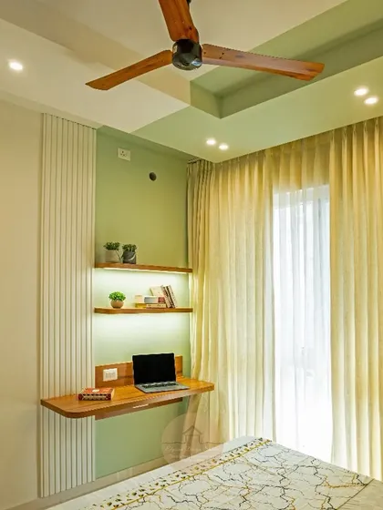 A bare corner becomes a functional and stylish home workspace. This transformation at a Godrej property features a custom floating desk, backlit shelves, and a calming green accent wall, proving that even small spaces can be highly productive.
