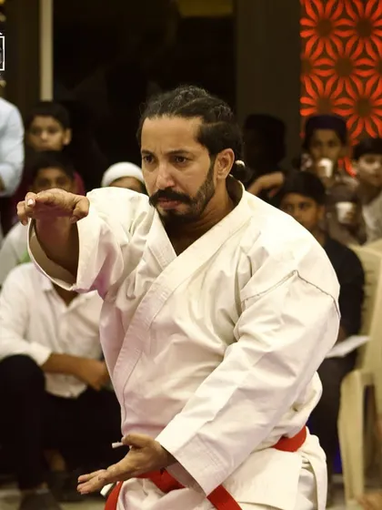 An experienced karateka demonstrates a kata, a sequence of movements, with precision and power. Katas are a fundamental part of karate, showcasing mastery of the art form.