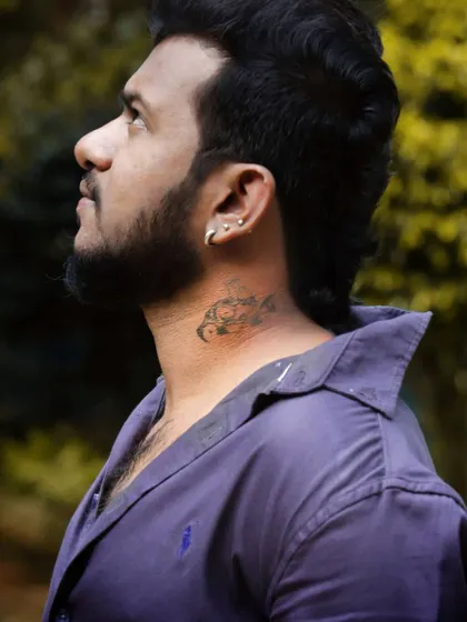 A profile shot showing off my scorpion neck tattoo, a part of my personal brand. 💫