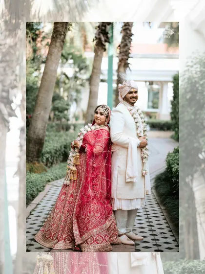 A beautiful portrait of a couple on their wedding day, standing back to back. It’s a stylish and modern take on a classic wedding pose, highlighting their stunning outfits.