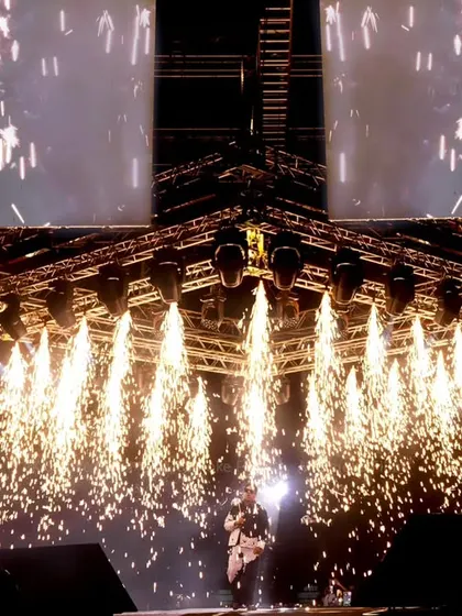 We excel at capturing peak moments, like this pyrotechnics display during a concert. This shot freezes the spectacular shower of sparks, adding to the drama of the live event.
